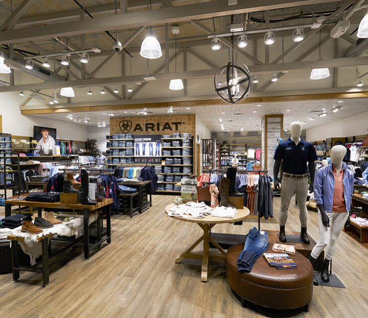 Ariat retail store interior featuring custom wood displays and ceiling beams