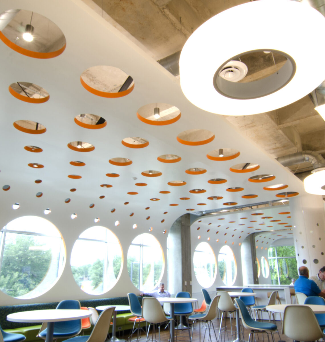Office lounge area with wood slat ceiling and blue accents