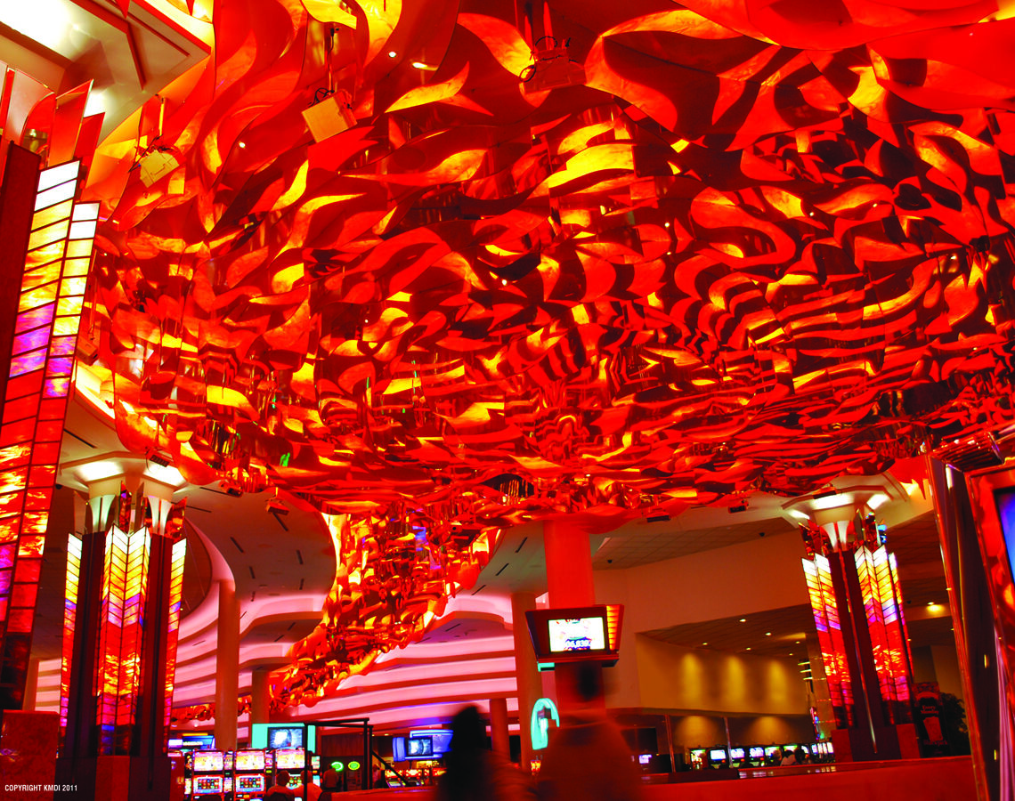 Curved white ceiling panels with green recessed lighting in casino